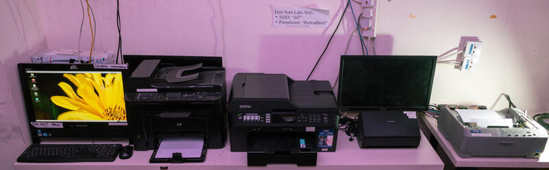 Photo of computer and printers on table
